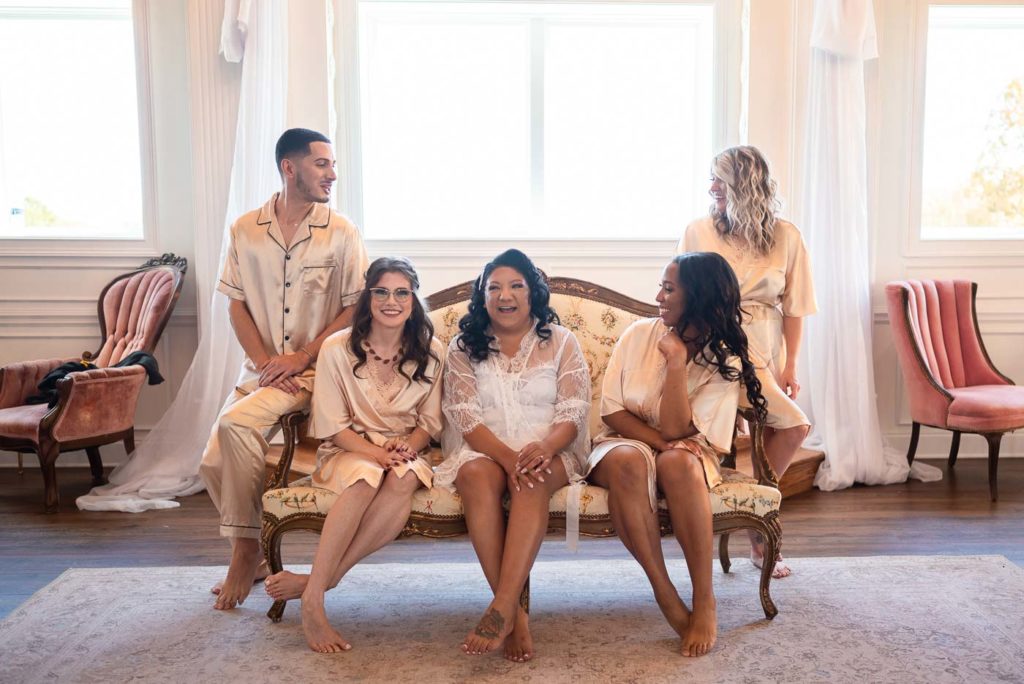 Bridal party sitting on couch in robes