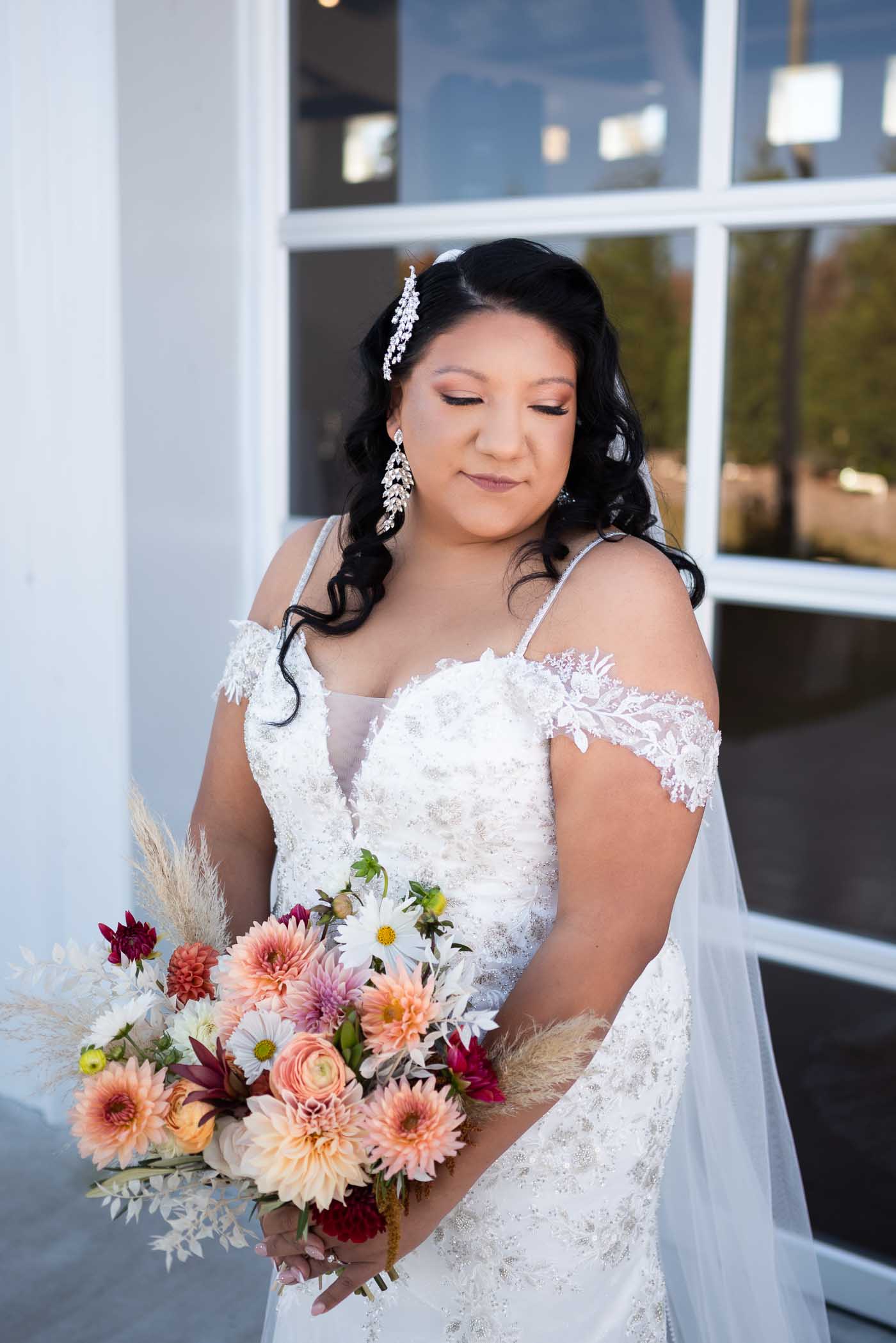 Bride glancing down at flowers
