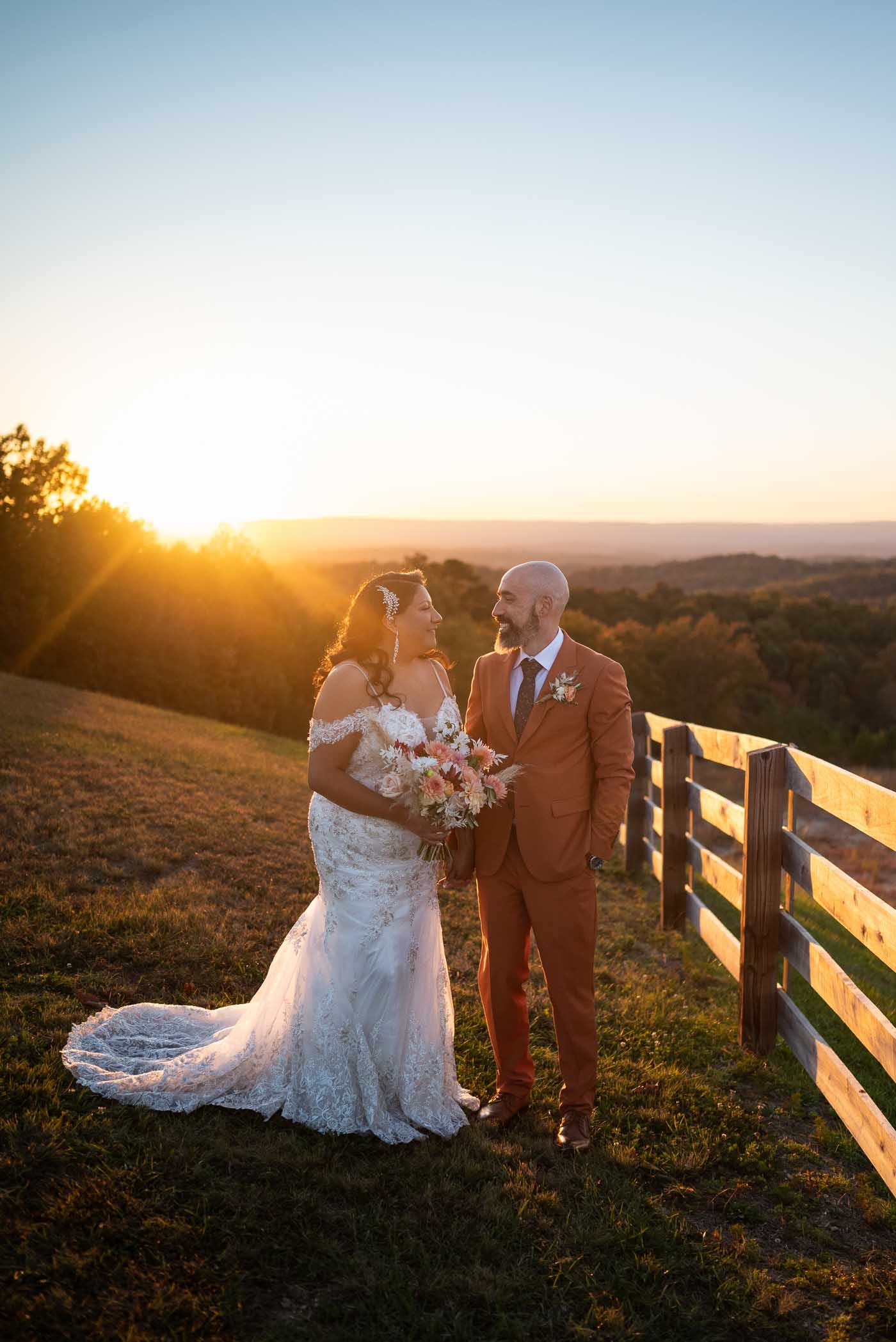 Bride and groom posing at sunset
