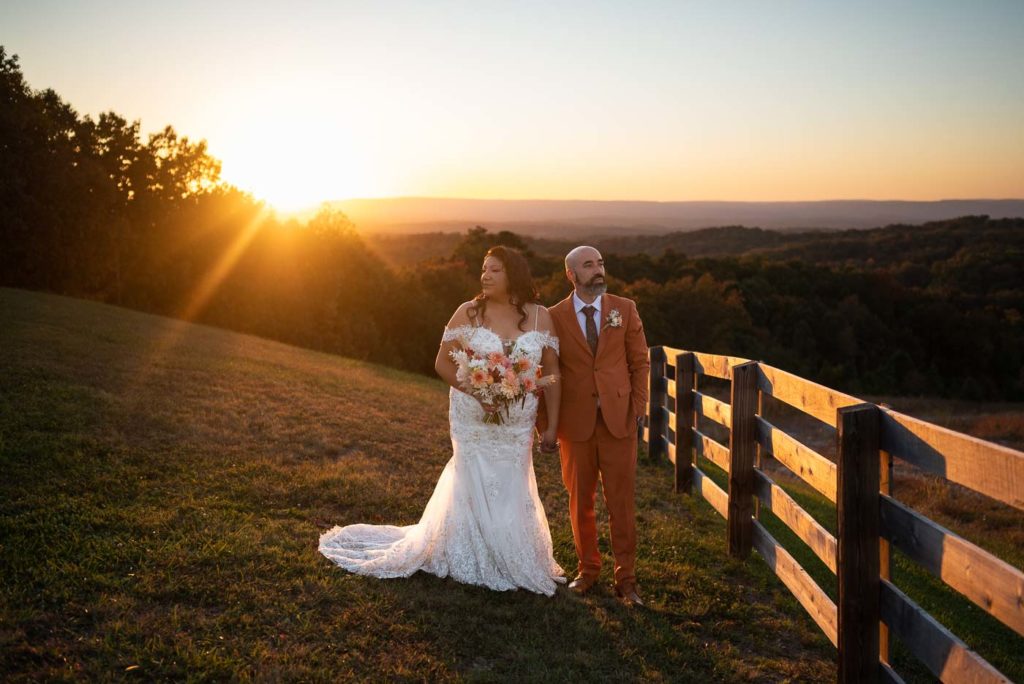 Bride and groom posing at sunset