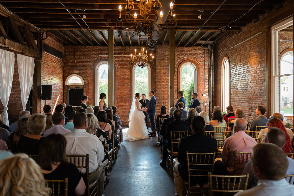 Bride and groom standing at the altar during ceremony at The Church on Main venue in Chattanooga